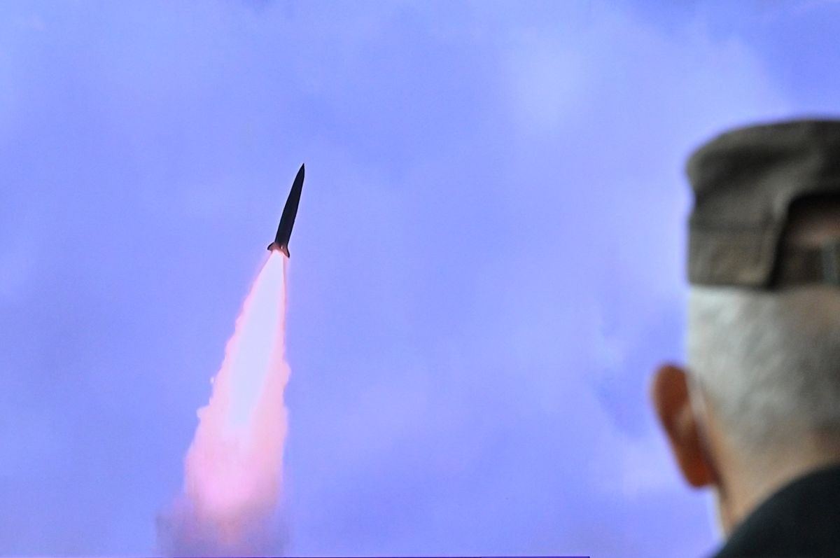 A man watches a television report on the launch of missiles by North Korea.